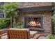 Stone fireplace surrounded by lush greenery, creating a cozy and private outdoor retreat at 11 Golden Sunray Ln, Las Vegas, NV 89135