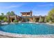Resort-style pool with waterfall features and sun loungers, set against a backdrop of a luxurious home at 11 Golden Sunray Ln, Las Vegas, NV 89135
