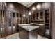 Elaborate walk-in closet featuring extensive storage, mirrored doors, and stylish granite countertops at 11 Golden Sunray Ln, Las Vegas, NV 89135