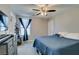 Comfortable bedroom featuring a ceiling fan, carpet and a large window at 1130 E Dorrell Ln, North Las Vegas, NV 89086
