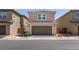 Two-story home with a two car garage, well-maintained landscaping and a tile roof at 1130 E Dorrell Ln, North Las Vegas, NV 89086