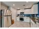 Modern kitchen features stainless steel appliances and white cabinetry at 1130 E Dorrell Ln, North Las Vegas, NV 89086
