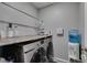 Clean laundry room with modern washer and dryer, storage space and updated decor at 1130 E Dorrell Ln, North Las Vegas, NV 89086