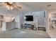 Spacious living room showcasing stairs, a powder room and open kitchen at 1130 E Dorrell Ln, North Las Vegas, NV 89086