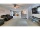 Bright living room featuring plush carpet, ceiling fan, and media center at 1130 E Dorrell Ln, North Las Vegas, NV 89086