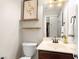Neutral powder room featuring floating shelves, a modern vanity, and stylish fixtures, creating an elegant space at 11402 Newton Commons Dr # 102, Las Vegas, NV 89135