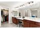 Primary bathroom featuring dual sinks, large vanity, dressing table, and walk-in closet, creating a spa-like experience at 11402 Newton Commons Dr # 102, Las Vegas, NV 89135