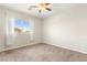 Bedroom with carpeted floor, ceiling fan, window, and neutral decor at 11402 Newton Commons Dr # 102, Las Vegas, NV 89135