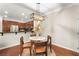 Well-lit dining room with a circular table, wooden chairs, and an open view of the modern kitchen at 11402 Newton Commons Dr # 102, Las Vegas, NV 89135