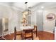 Bright dining area with modern lighting and comfortable seating for four, and neutral walls at 11402 Newton Commons Dr # 102, Las Vegas, NV 89135
