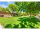 Beautifully landscaped front yard featuring mature trees and lush green lawn at 11402 Newton Commons Dr # 102, Las Vegas, NV 89135