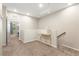 Second floor hallway with neutral paint, beige carpet, and gold console table offers a stylish transition area at 11402 Newton Commons Dr # 102, Las Vegas, NV 89135
