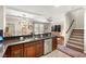 Open concept kitchen with breakfast bar, stainless steel appliances, and seamless transition to the living area at 11402 Newton Commons Dr # 102, Las Vegas, NV 89135
