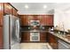 Modern kitchen features sleek stainless steel appliances, dark cabinetry, and complementary granite countertops at 11402 Newton Commons Dr # 102, Las Vegas, NV 89135