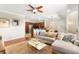 Open-concept living area with a comfortable sofa, stylish decor, and warm hardwood flooring at 11402 Newton Commons Dr # 102, Las Vegas, NV 89135