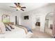 Spacious primary bedroom features modern decor, ceiling fan, and view to attached bathroom with dual sinks at 11402 Newton Commons Dr # 102, Las Vegas, NV 89135