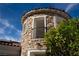 Exterior of the home showcasing a stone turret and well-maintained landscaping at 11830 Kingsbarns Ct, Las Vegas, NV 89141