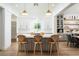 Bright kitchen featuring a large island with seating, pendant lighting, and modern appliances at 11830 Kingsbarns Ct, Las Vegas, NV 89141