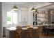 Well-designed kitchen with an island, modern appliances, and open shelving, adjacent to dining area at 11830 Kingsbarns Ct, Las Vegas, NV 89141