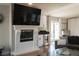 Bright living room with a fireplace, hardwood floors, and convenient wet bar at 11830 Kingsbarns Ct, Las Vegas, NV 89141