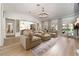 Open-concept living room with modern lighting, comfortable seating, and access to the backyard at 11830 Kingsbarns Ct, Las Vegas, NV 89141