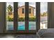 View from bedroom through french doors to backyard, pool and neighboring building at 11830 Kingsbarns Ct, Las Vegas, NV 89141