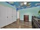 The bedroom features unique themed ceiling, wood laminate floors, and closet space at 1335 Passiflora Dr, Henderson, NV 89002