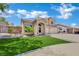 Beautiful two-story house with manicured lawn and inviting curb appeal on a sunny day at 1335 Passiflora Dr, Henderson, NV 89002