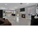 Open concept living room with fireplace, tile flooring, and seamless access to the kitchen at 1335 Passiflora Dr, Henderson, NV 89002