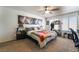 A spacious bedroom with a ceiling fan, a large bed, and lion artwork on the wall at 1575 W Warm Springs Rd # 2822, Henderson, NV 89014