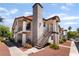 Exterior view of a two-story condominium complex with light stucco, dark trim, and stairs at 1575 W Warm Springs Rd # 2822, Henderson, NV 89014