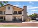Exterior view of a two-story condo with a balcony, covered parking, and desert landscaping at 1575 W Warm Springs Rd # 2822, Henderson, NV 89014