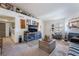 A living room with a fireplace, neutral carpet, white walls, and a TV at 1575 W Warm Springs Rd # 2822, Henderson, NV 89014