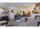 Living room with neutral carpet, white walls, fireplace, and adjacent dining at 1575 W Warm Springs Rd # 2822, Henderson, NV 89014