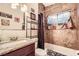 Bathroom features a shower/tub combo, a granite countertop vanity, and tile walls at 1607 Vegas Valley Dr, Las Vegas, NV 89169