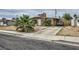 Ranch home with a stone chimney, desert landscaping and extended driveway at 1607 Vegas Valley Dr, Las Vegas, NV 89169