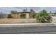 Single story home featuring a stone chimney and desert landscaping at 1607 Vegas Valley Dr, Las Vegas, NV 89169