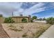 Single story home with desert landscaping and a stone chimney at 1607 Vegas Valley Dr, Las Vegas, NV 89169