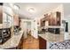 Well-lit kitchen features granite counters, dark wood cabinets, and stainless steel appliances at 1607 Vegas Valley Dr, Las Vegas, NV 89169