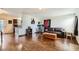 Open concept living room with hardwood floors, leather sofa and kitchen access at 1607 Vegas Valley Dr, Las Vegas, NV 89169