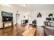 Spacious living room featuring hardwood floors, television and open layout at 1607 Vegas Valley Dr, Las Vegas, NV 89169