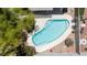 Private backyard with a pool, covered patio, and lush greenery for relaxation at 1906 Desert Sage Ave, North Las Vegas, NV 89031