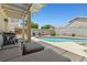 Stunning backyard pool with lounge area, perfect for enjoying sunny days and outdoor living at 1906 Desert Sage Ave, North Las Vegas, NV 89031