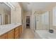 Bright bathroom with a glass-enclosed shower and a soaking tub at 1906 Desert Sage Ave, North Las Vegas, NV 89031