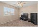 This bedroom has neutral walls, carpeted floors, a large window, and a ceiling fan at 1906 Desert Sage Ave, North Las Vegas, NV 89031