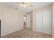 This bedroom features neutral carpet and a closet, with access to the bathroom at 1906 Desert Sage Ave, North Las Vegas, NV 89031