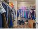 This walk-in closet features a clothes rack with a variety of clothing, shoes and storage boxes at 1906 Desert Sage Ave, North Las Vegas, NV 89031