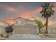 Charming two-story home with a well-maintained lawn, mature palm tree and a three car garage at 1906 Desert Sage Ave, North Las Vegas, NV 89031