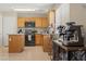 Well-lit kitchen with wood cabinets, tile floors, and granite countertops at 1906 Desert Sage Ave, North Las Vegas, NV 89031