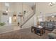 Inviting living room featuring a staircase, comfortable seating, and ample natural light at 1906 Desert Sage Ave, North Las Vegas, NV 89031